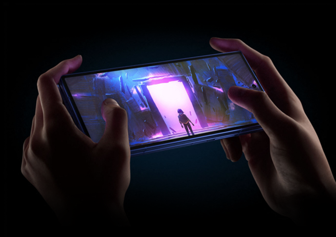 A close-up of a pair of hands playing a game with the Fold7 held sideways like a gamepad