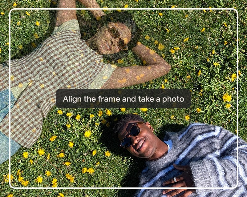 The image shows two people lying on a lawn, highlighting how Pixel's 'Add Me' camera feature ensures everyone is in the photo